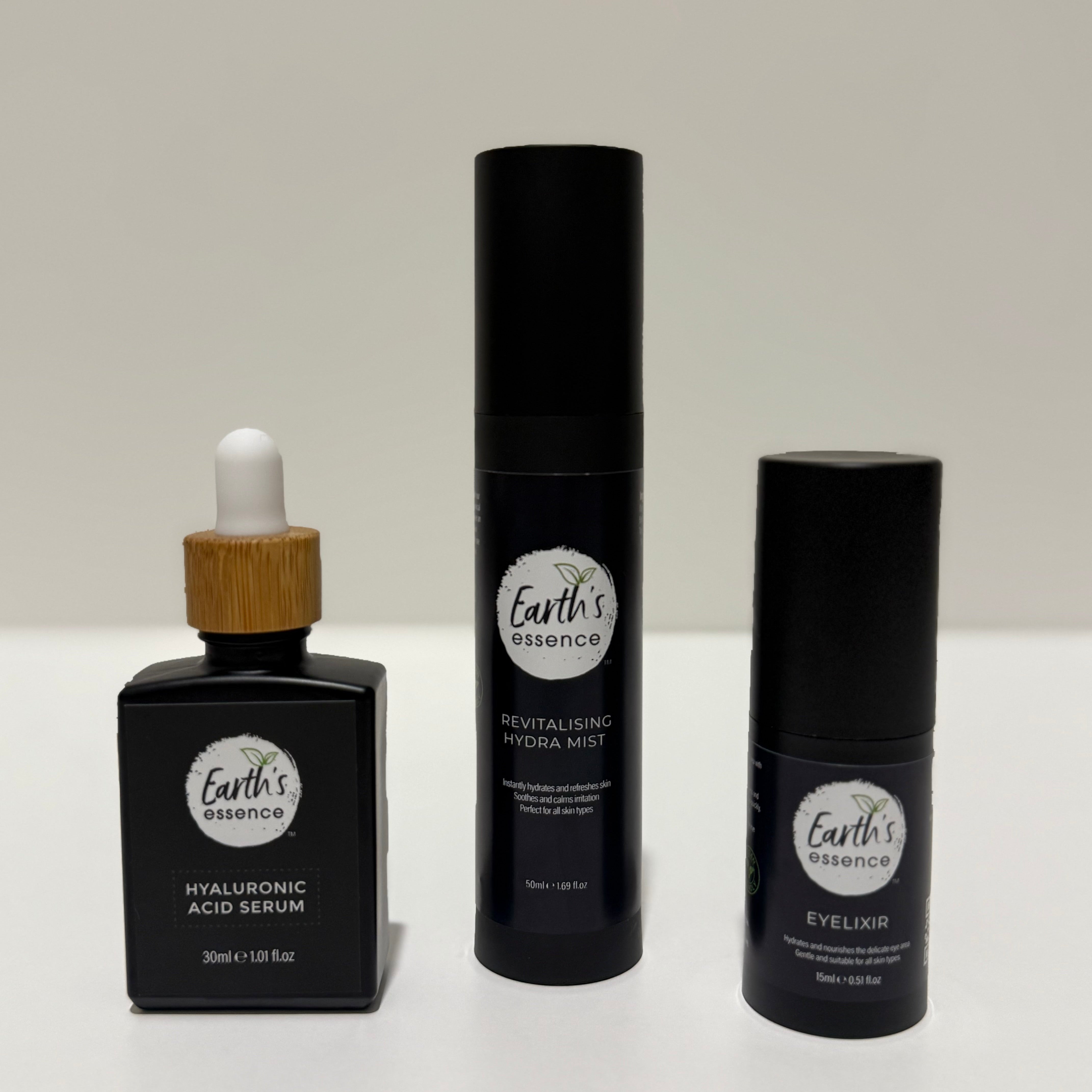 Three black cosmetic bottles with Earth's Essence branding on a white background
