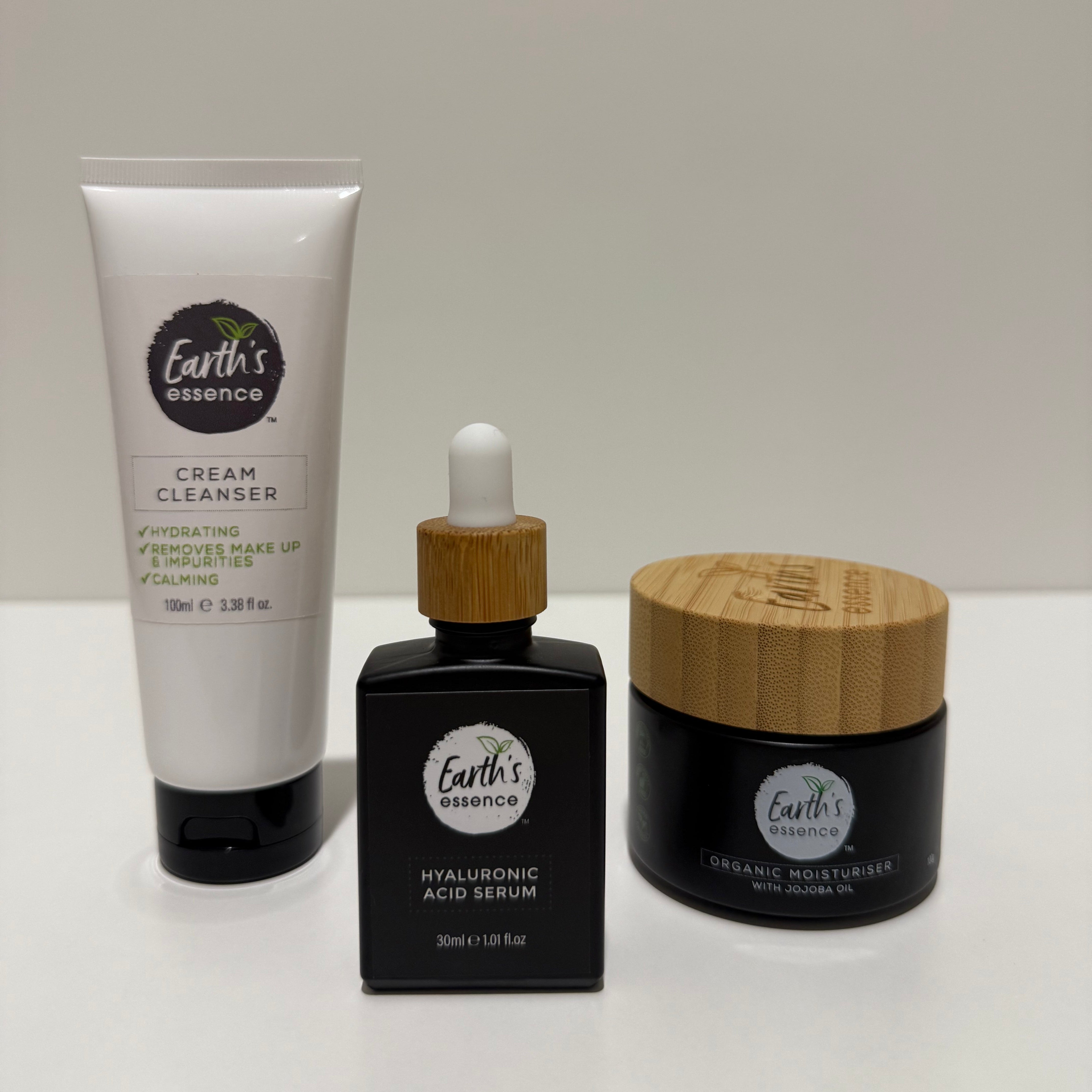 Set of skincare products with wooden applicators on a white surface
